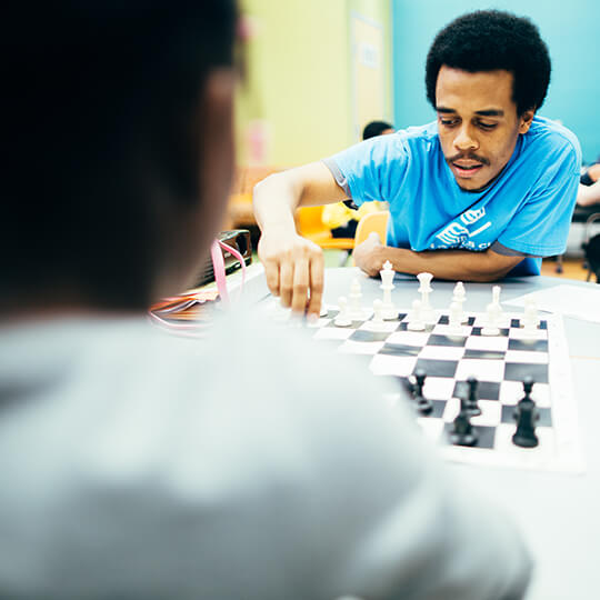 BGCMA leader and youth playing chess